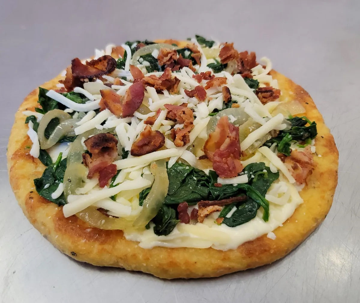 Delicious keto Gourmet Carmelized Onion, Bacon and Spinach Pizza perfect for weight management and wellness