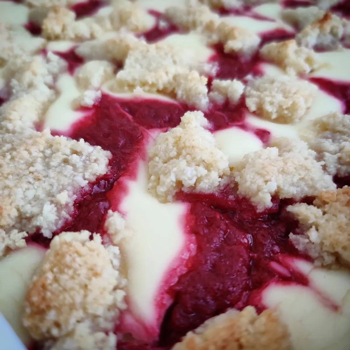 A delicious low-carb Raspberry Cheesecake Crumble Bar on a classic favorite