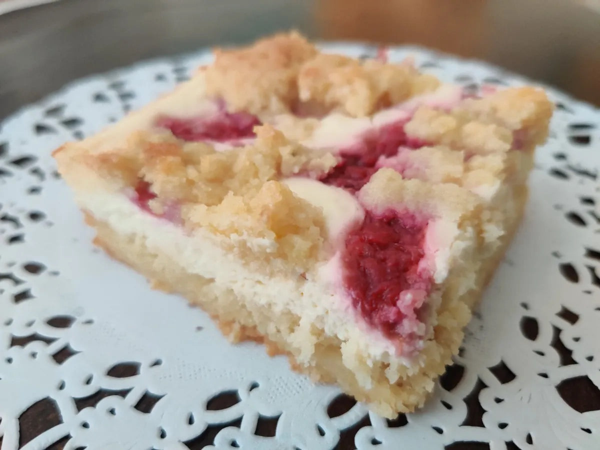 A delicious low-carb Raspberry Cheesecake Crumble Bar on a classic favorite